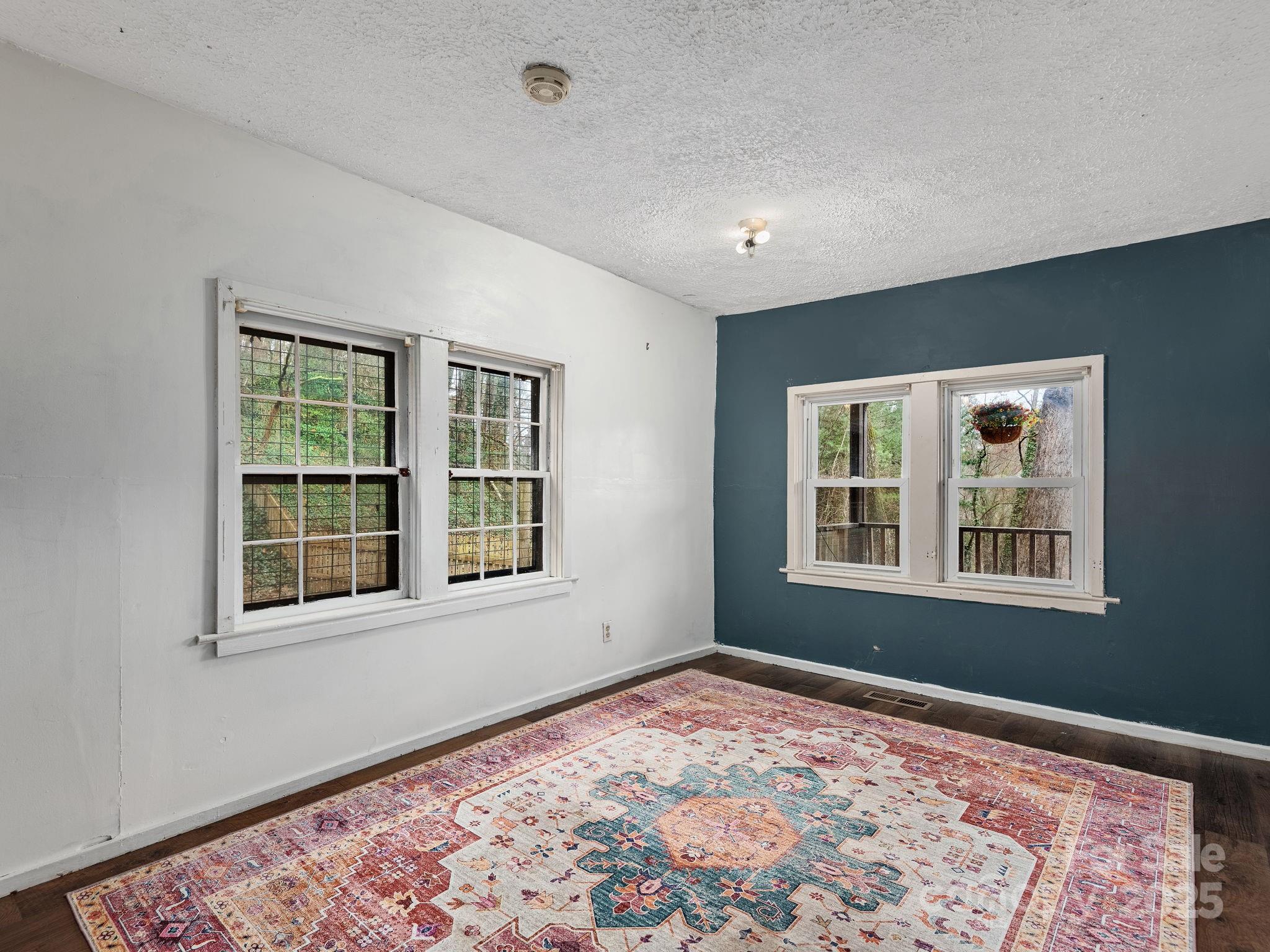 32 Saunooke Road Asheville, NC 28805 - Photo 12 of 17 a view of an empty room with a window and wooden floor