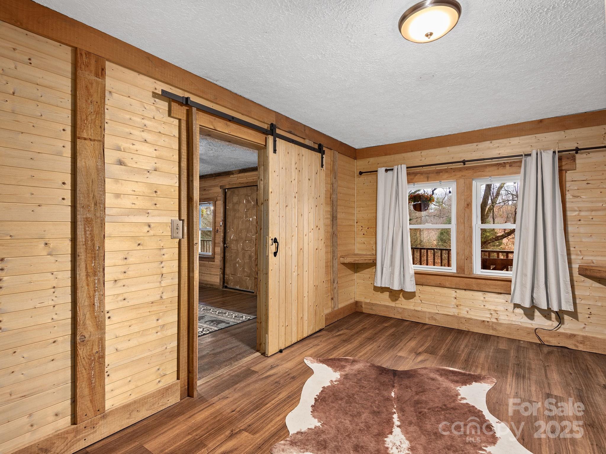 32 Saunooke Road Asheville, NC 28805 - Photo 10 of 17 a view of a hallway with wooden floor and a window