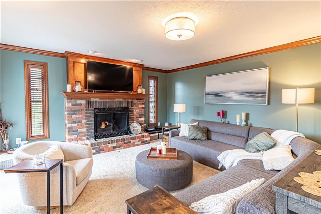331 Cobblestone Circle McKees Rocks, PA 15136 - Photo 14 of 44 a living room with furniture a flat screen tv and a fireplace