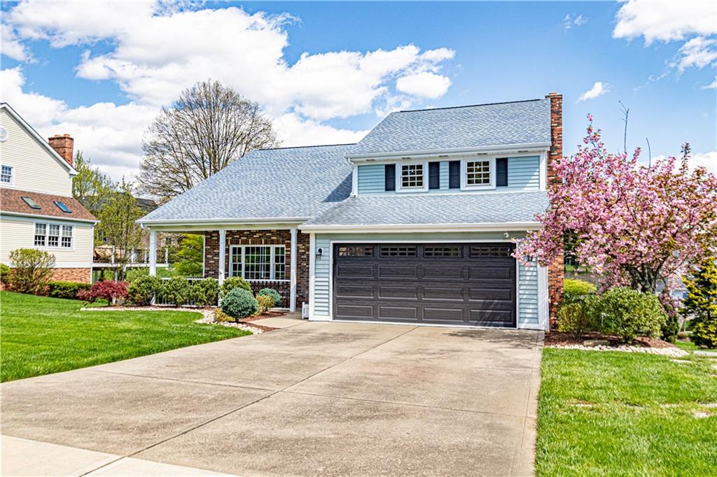 331 Cobblestone Circle McKees Rocks, PA 15136 - Photo 2 of 44 a front view of a house with a yard and garage