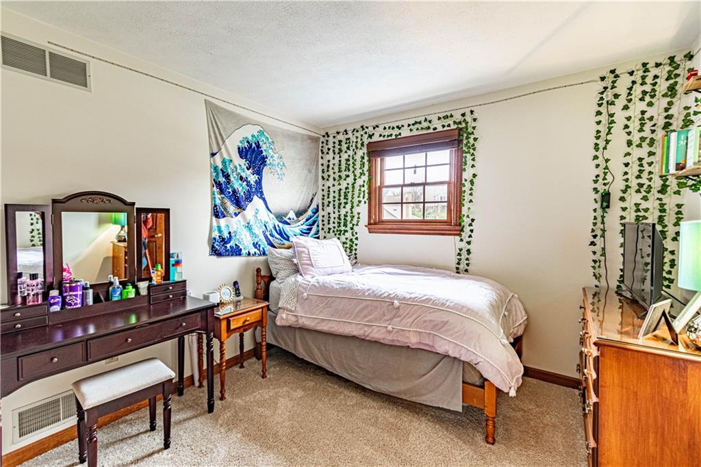 331 Cobblestone Circle McKees Rocks, PA 15136 - Photo 30 of 44 a bedroom with a bed table closet and a window