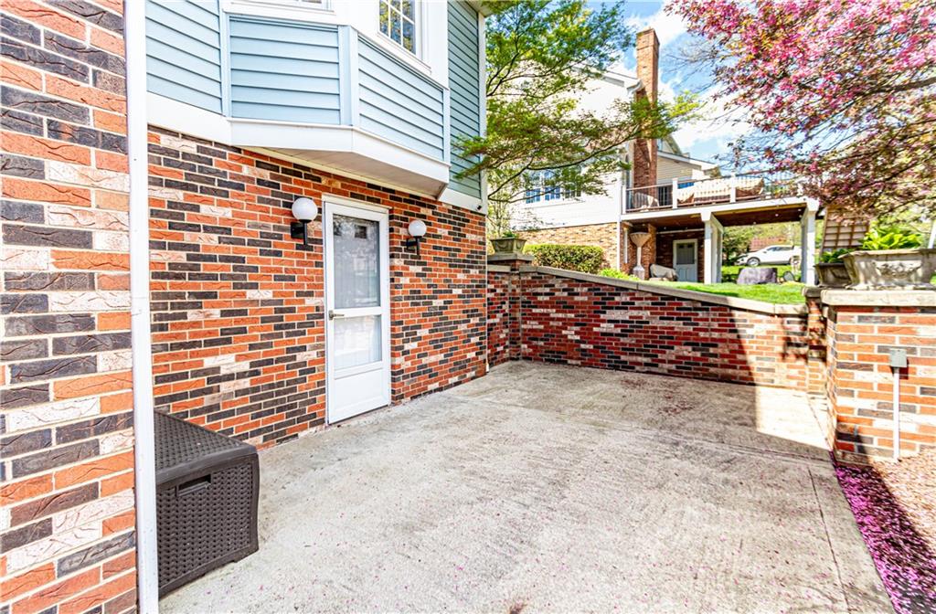 331 Cobblestone Circle McKees Rocks, PA 15136 - Photo 39 of 44 a view of a yard with brick wall and potted plants