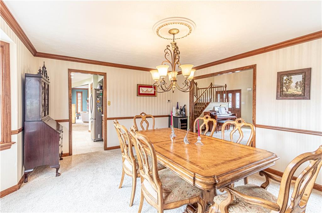 331 Cobblestone Circle McKees Rocks, PA 15136 - Photo 9 of 44 a dining room with furniture a chandelier and wooden floor