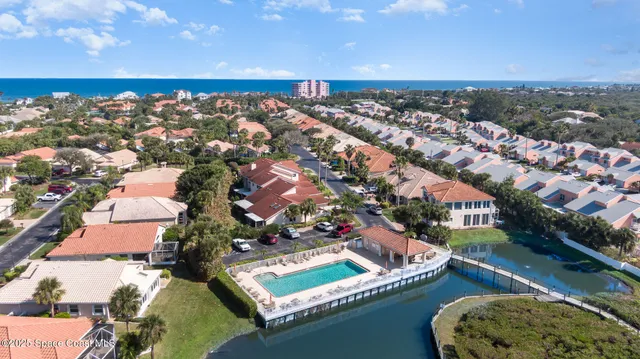 an aerial view of a house with a lake view