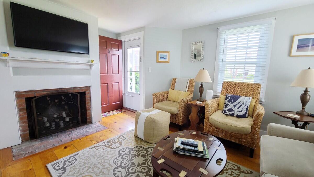 670 Shore Road, Unit 5 Truro, MA 02666 - Photo 7 of 22 a living room with furniture a flat screen tv and a fireplace