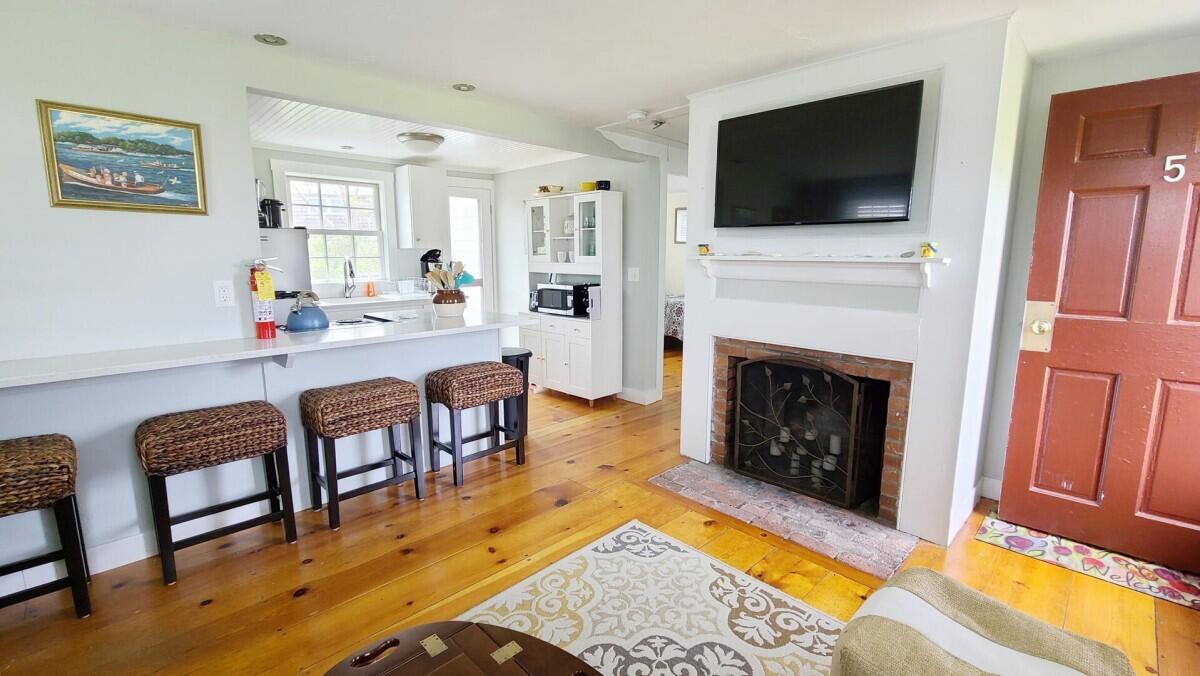 670 Shore Road, Unit 5 Truro, MA 02666 - Photo 9 of 22 a living room with furniture a flat screen tv and a fireplace