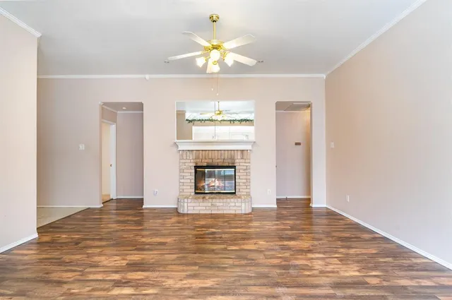 a view of a livingroom with a window and a fireplace