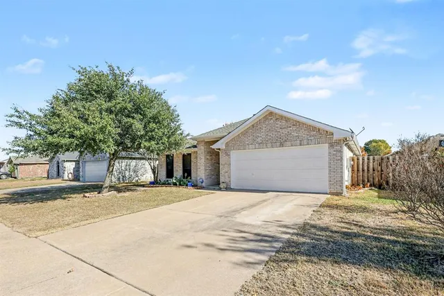 a view of a house with a yard and garage