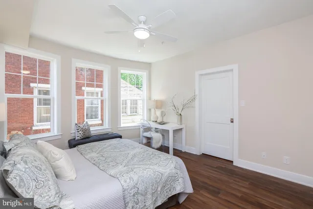 a bedroom with a bed and a large window
