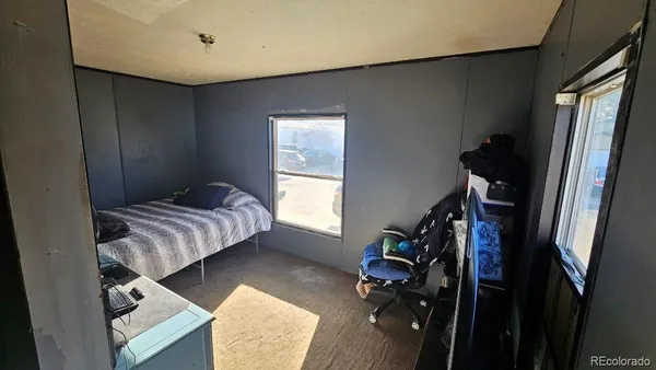 a bedroom with a bed closet and a window