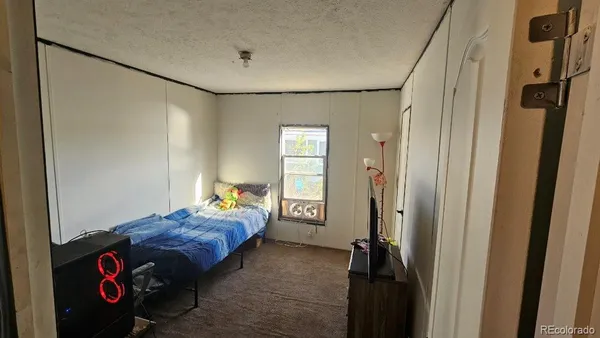 a bedroom with a bed and a mirror