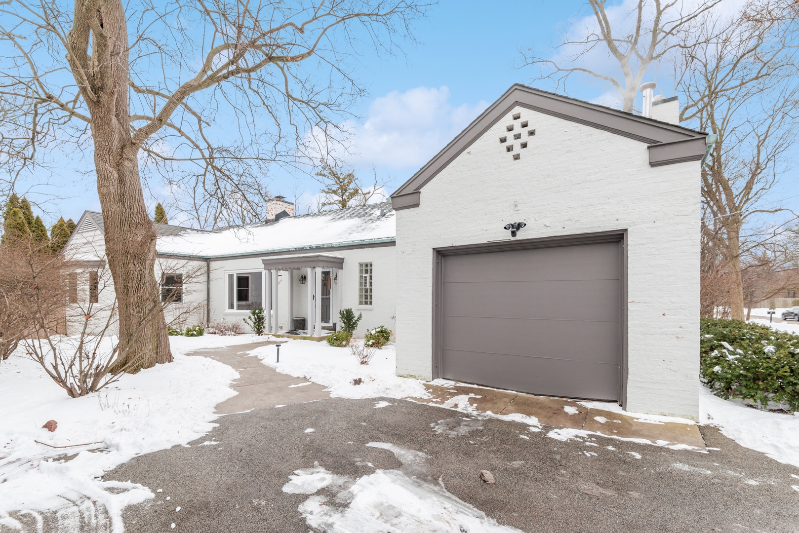 61 Ridge Road Highland Park, IL 60035 - Photo 1 of 25 a view of a white house with a large tree