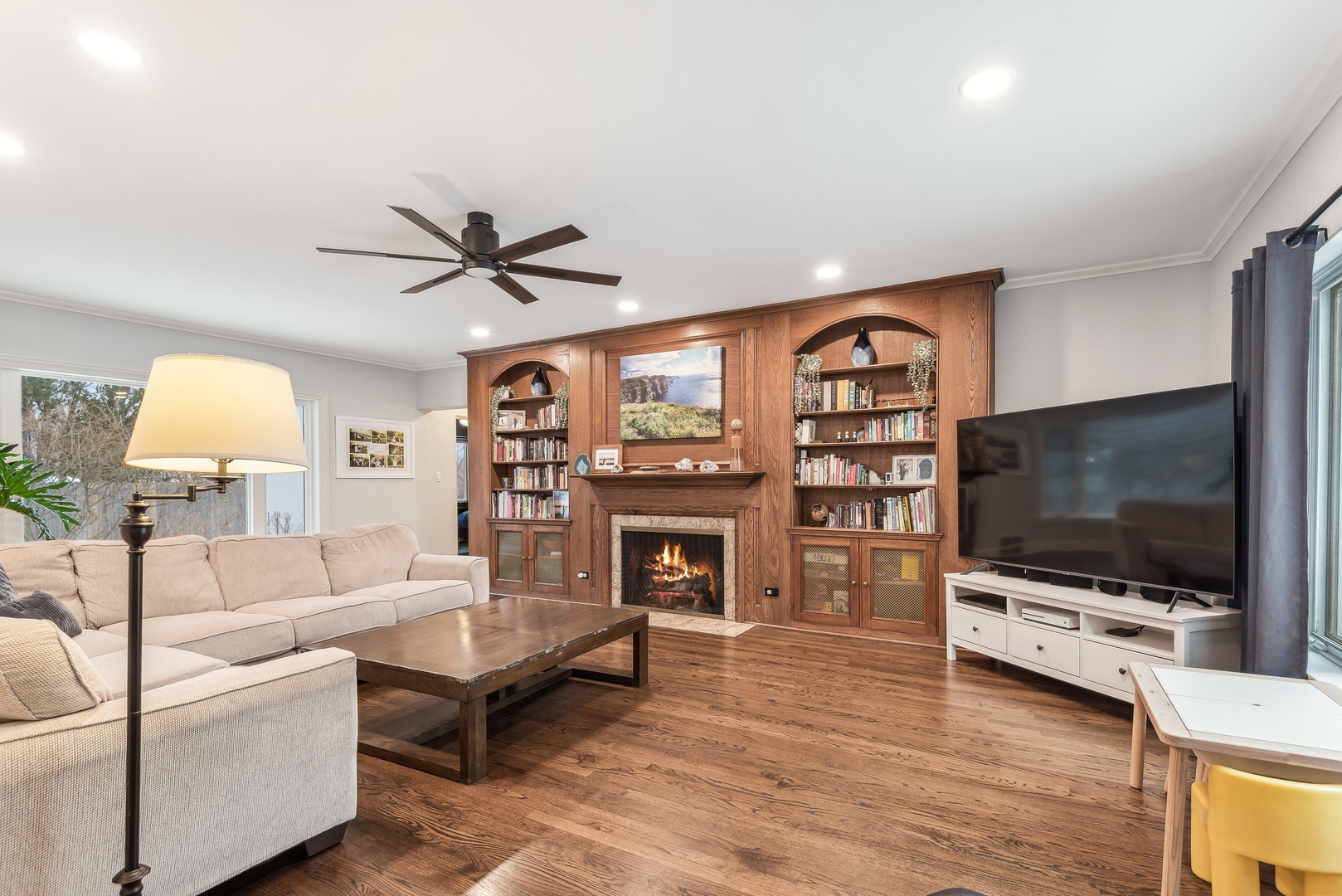 61 Ridge Road Highland Park, IL 60035 - Photo 7 of 25 a living room with fireplace furniture and a flat screen tv
