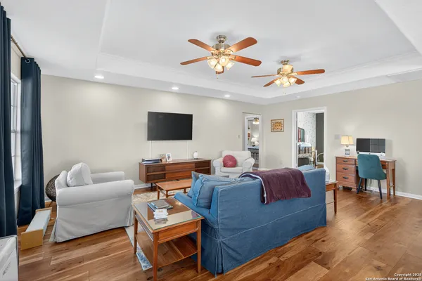 a living room with furniture ceiling fan and a window