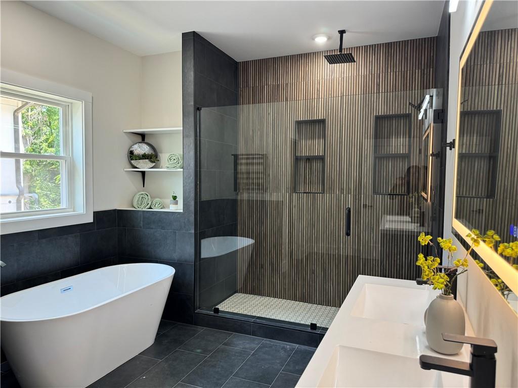 1312 Pine Avenue Atlanta, GA 30344 - Photo 13 of 17 a bathroom with a white bath tub a sink and a shower