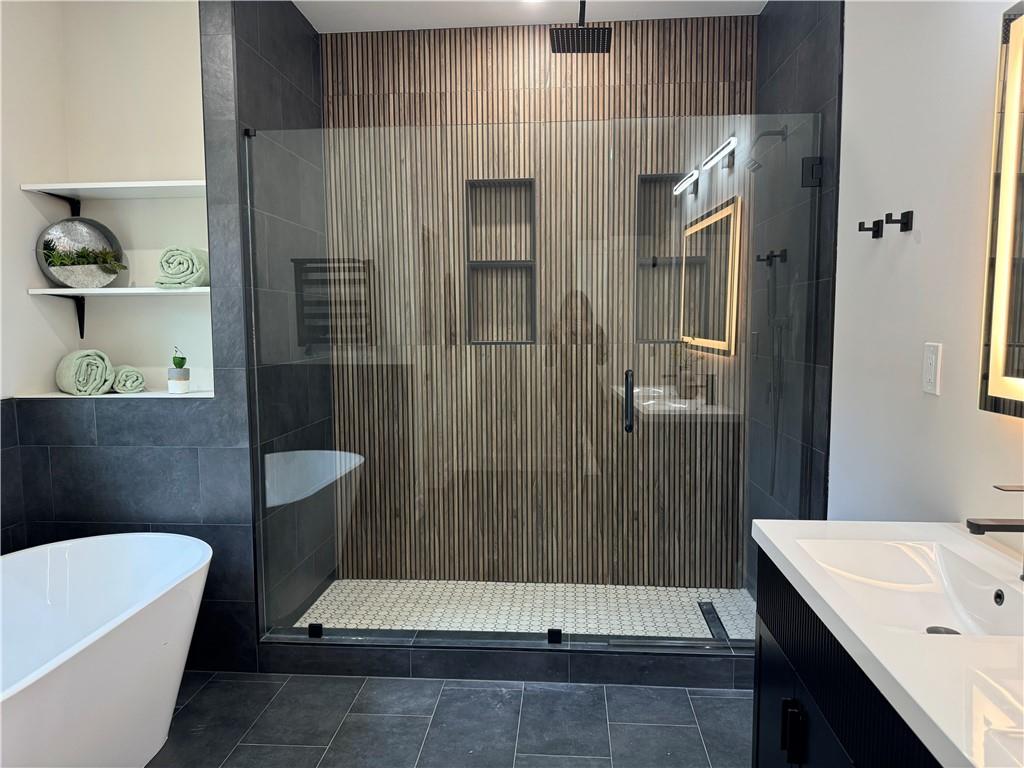 1312 Pine Avenue Atlanta, GA 30344 - Photo 14 of 17 a bathroom with a tub a sink and a shower