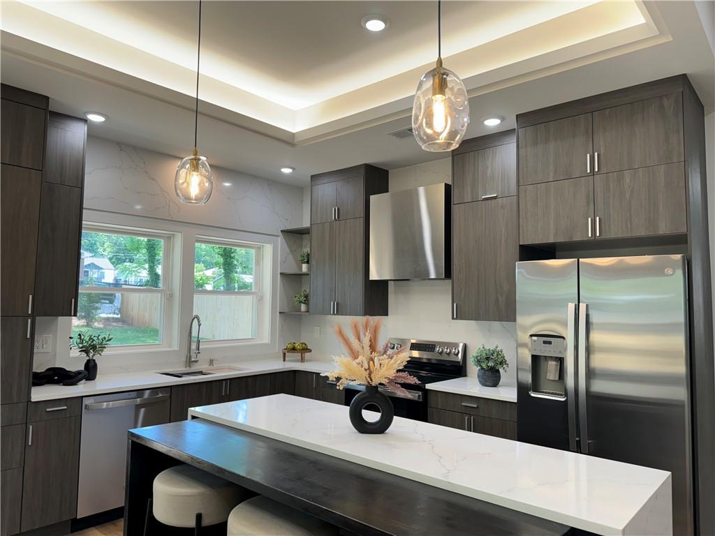 1312 Pine Avenue Atlanta, GA 30344 - Photo 3 of 17 a kitchen with stainless steel appliances a table chairs refrigerator and window