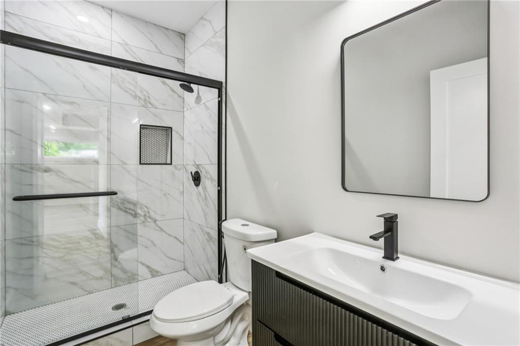 1312 Pine Avenue Atlanta, GA 30344 - Photo 10 of 17 a bathroom with a sink toilet and shower