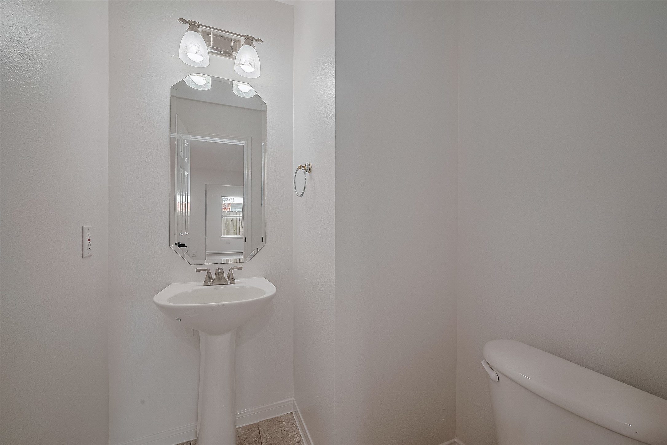 3223 Candlepine Drive Spring, TX 77388 - Photo 16 of 34 a bathroom with a toilet sink and mirror