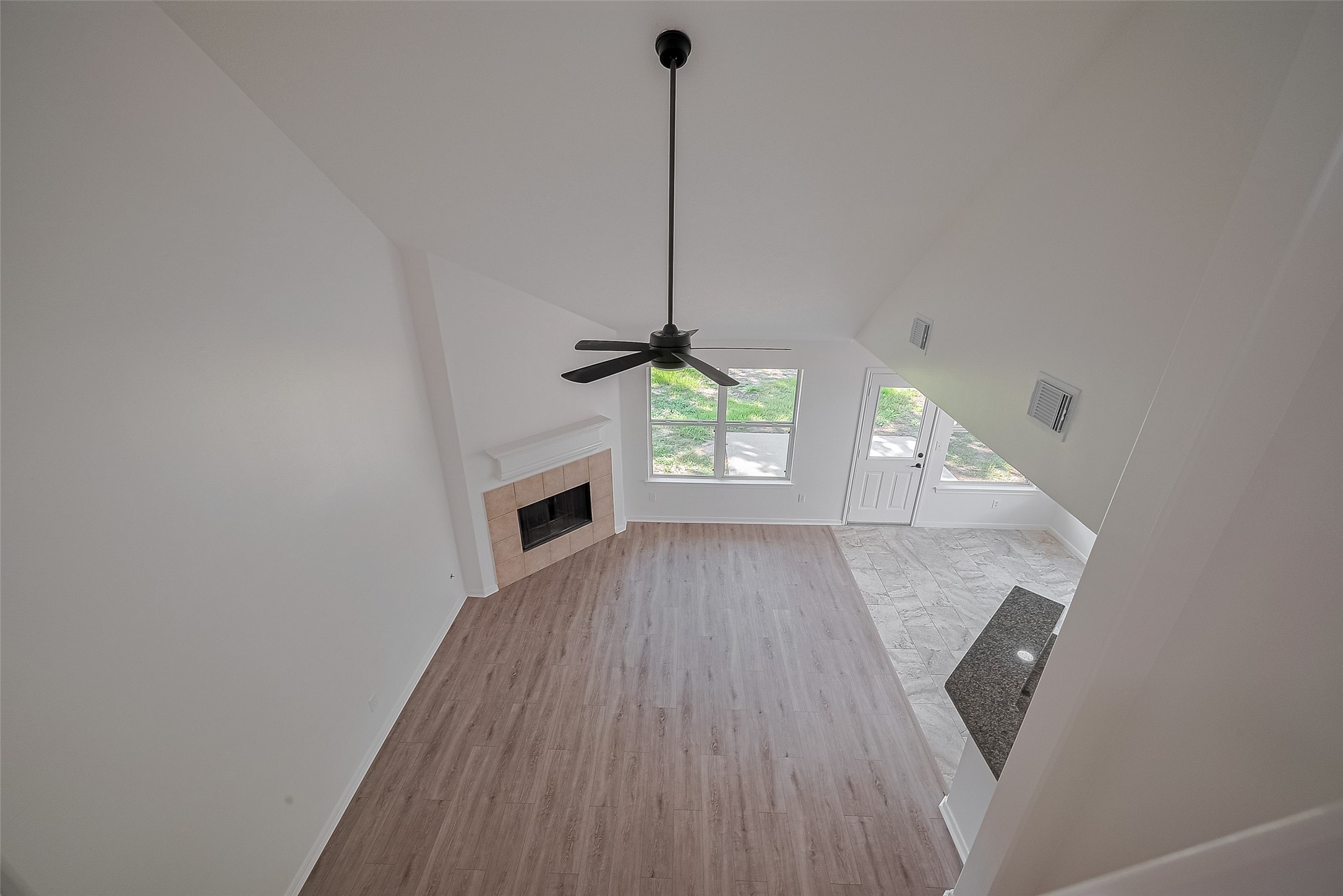 3223 Candlepine Drive Spring, TX 77388 - Photo 24 of 34 a view of a hallway with wooden floor and a fireplace