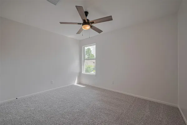 a view of room with window and ceiling fan