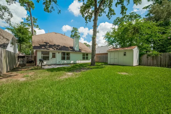 a view of a house with a backyard