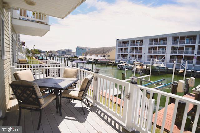 617 Salt Spray Road, Unit B Ocean City, MD 21842 - Photo 2 of 72 a view of a chairs and table on the balcony