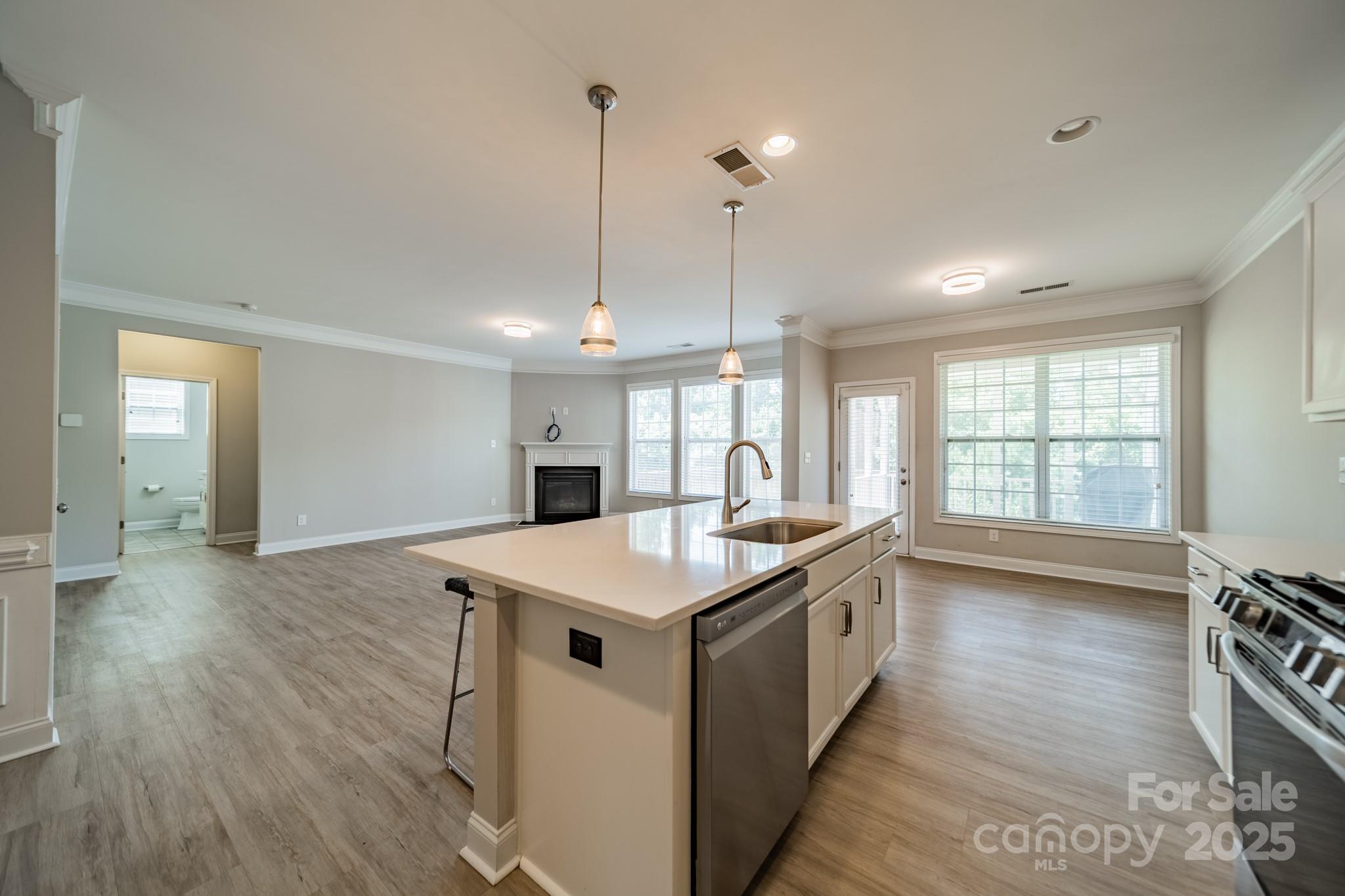 9229 Inverness Bay Road Charlotte, NC 28278 - Photo 11 of 41 a kitchen with a stove and a wooden floor