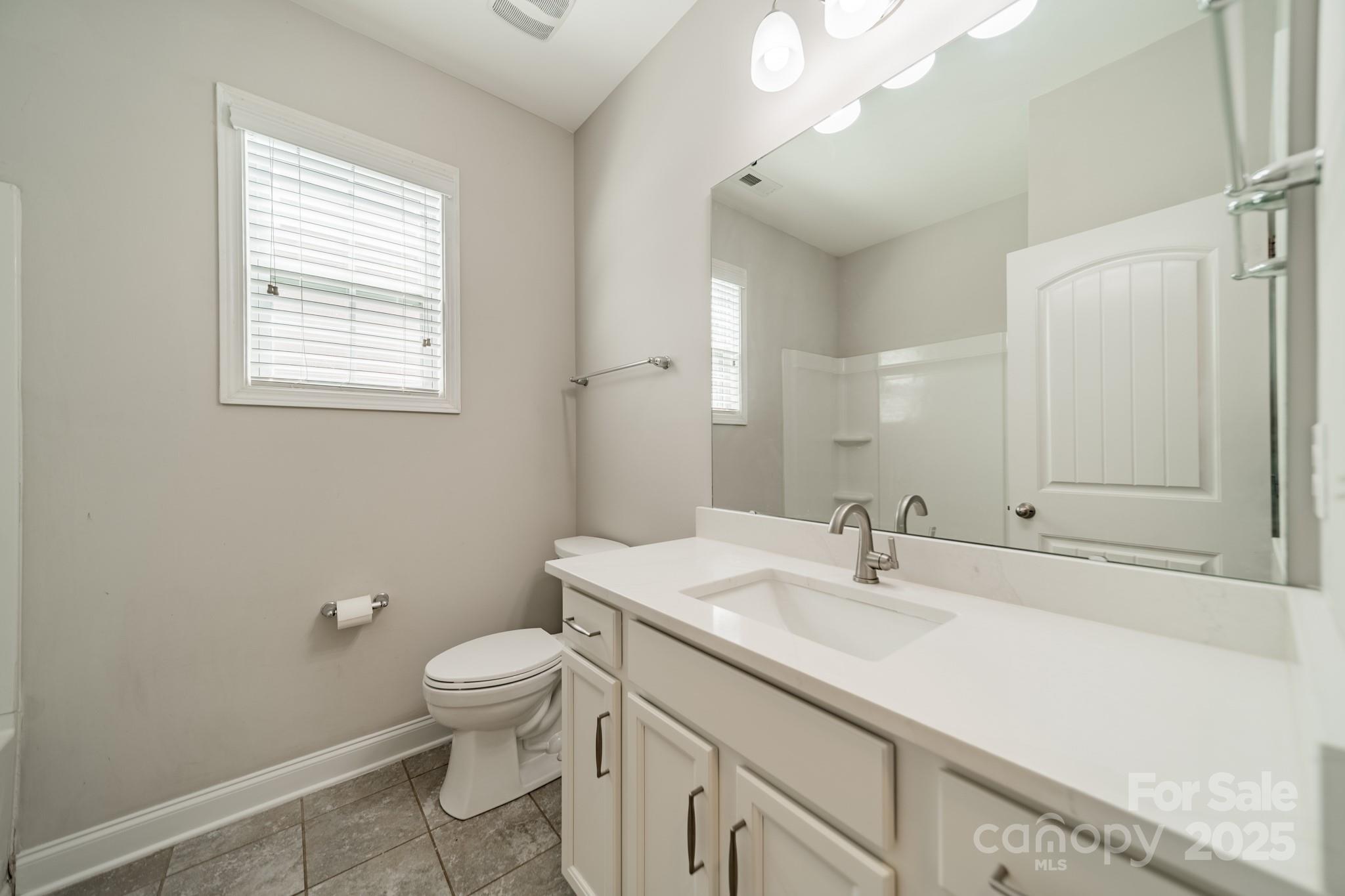 9229 Inverness Bay Road Charlotte, NC 28278 - Photo 13 of 41 a bathroom with a sink a toilet and a mirror