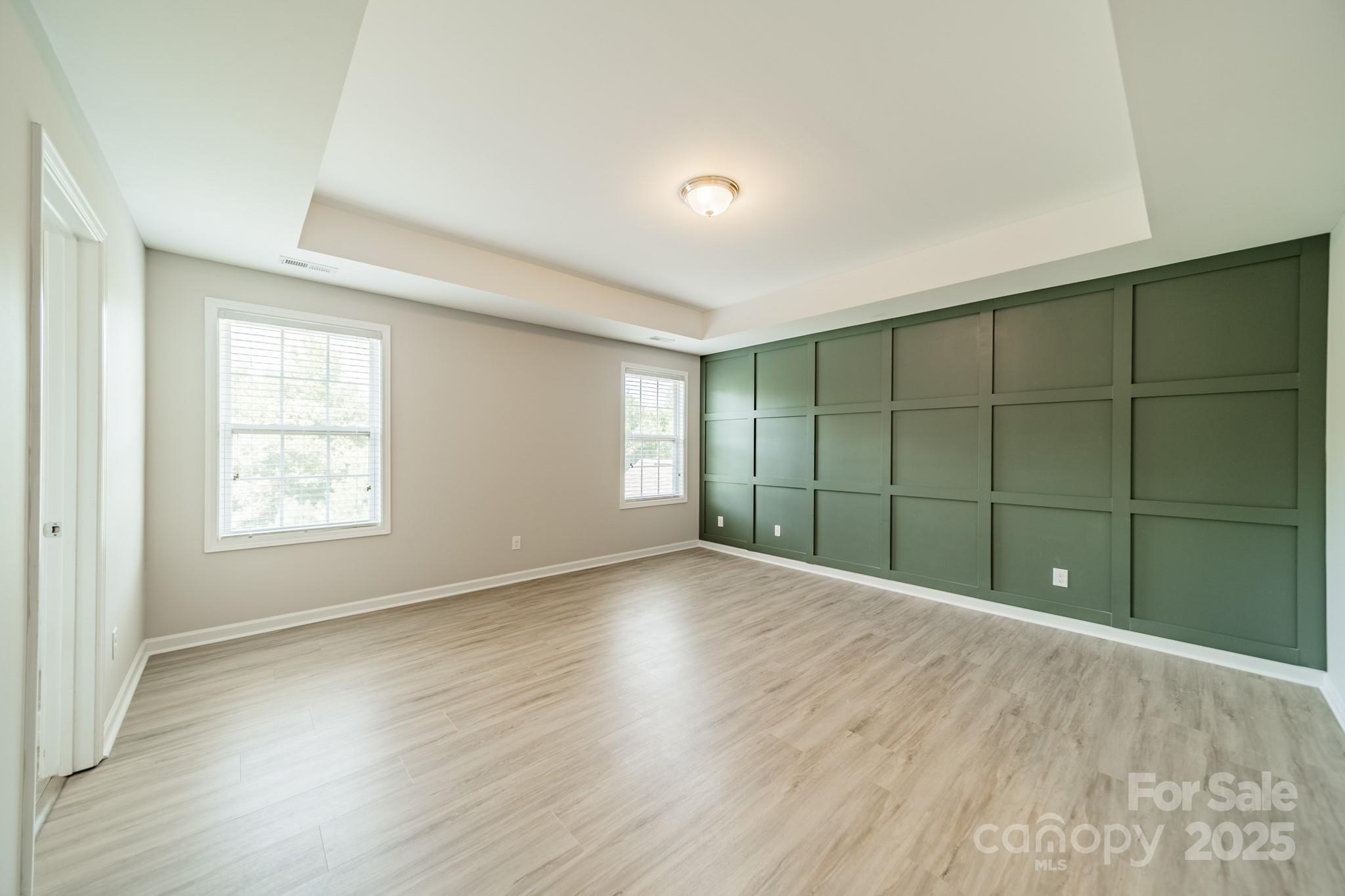 9229 Inverness Bay Road Charlotte, NC 28278 - Photo 14 of 41 a view of an empty room with wooden floor and a window
