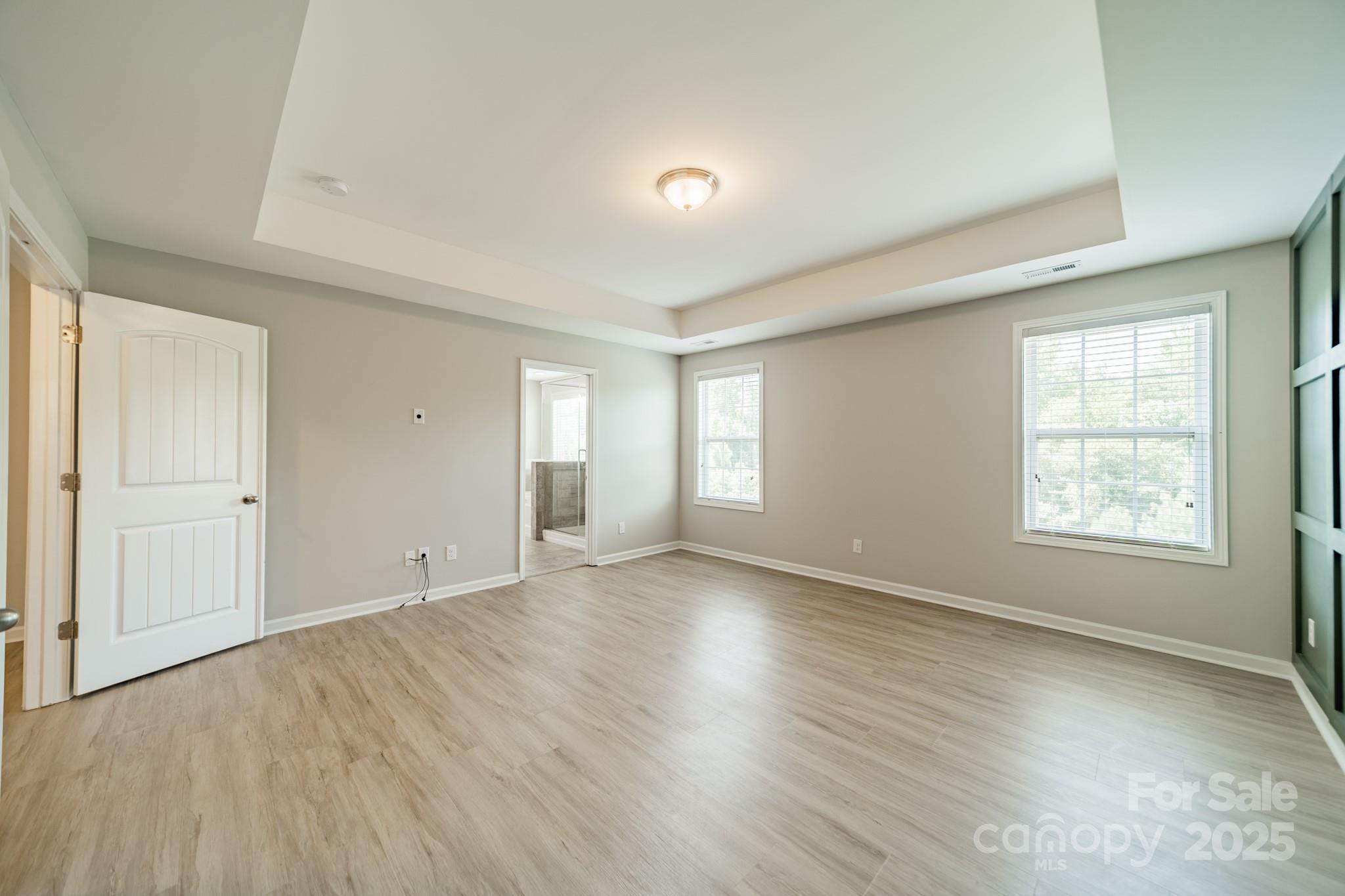 9229 Inverness Bay Road Charlotte, NC 28278 - Photo 15 of 41 a view of an empty room with wooden floor and window