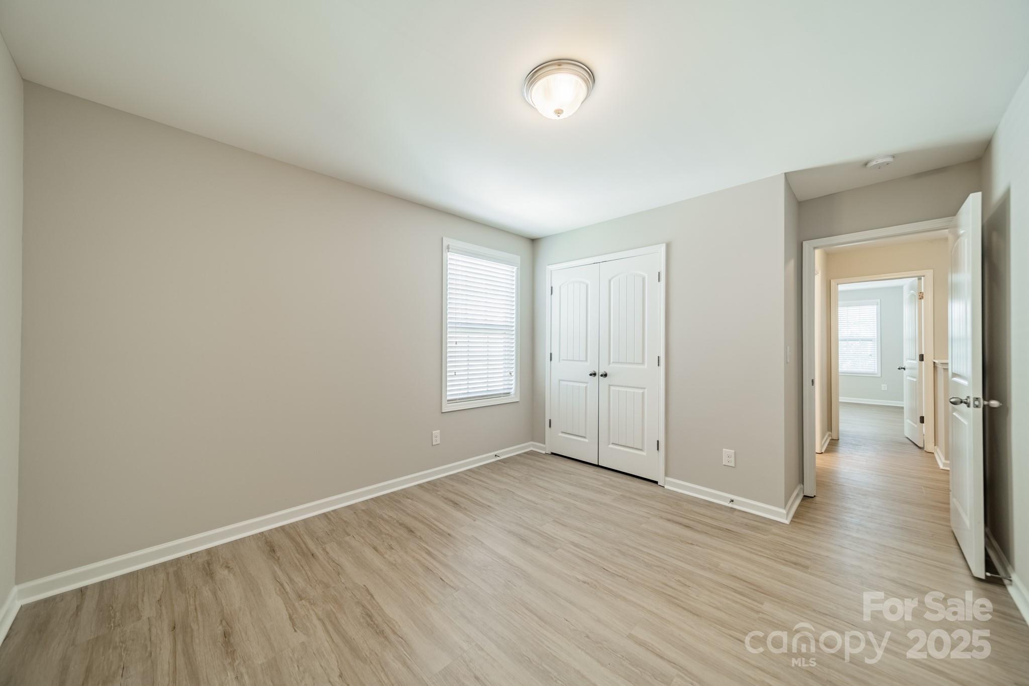9229 Inverness Bay Road Charlotte, NC 28278 - Photo 20 of 41 an empty room with wooden floor and windows