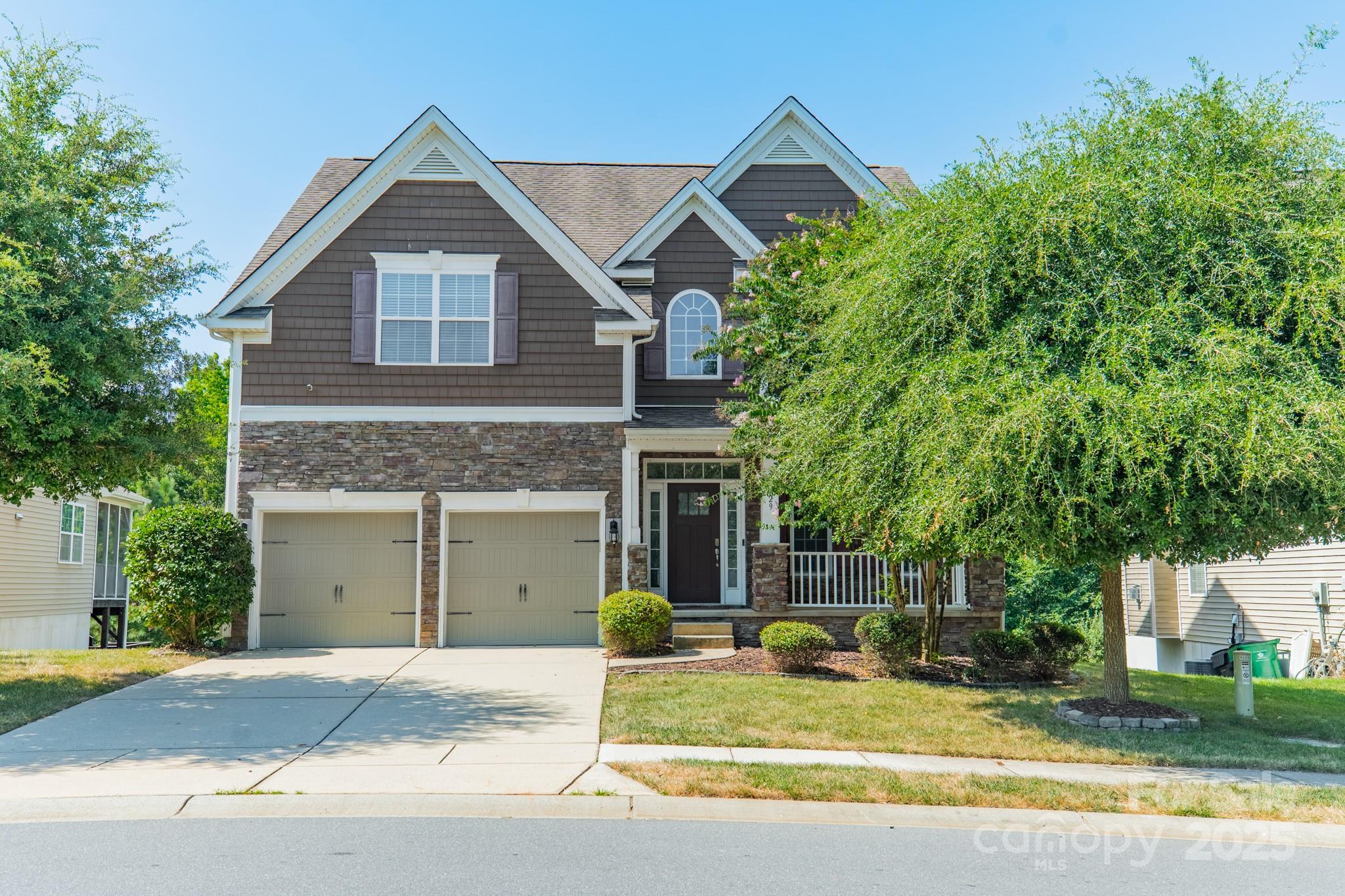 9229 Inverness Bay Road Charlotte, NC 28278 - Photo 2 of 41 a view of a house with a yard and large tree and plants