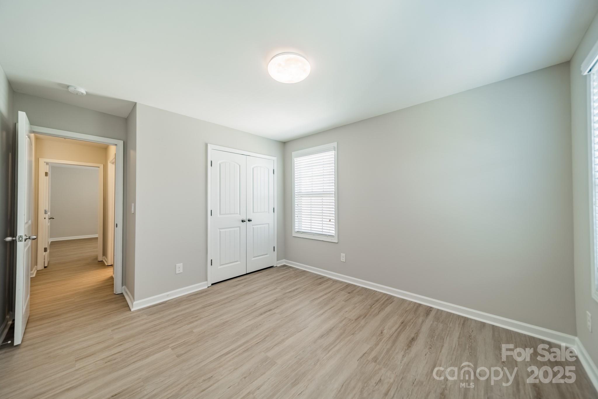 9229 Inverness Bay Road Charlotte, NC 28278 - Photo 22 of 41 an empty room with wooden floor and windows