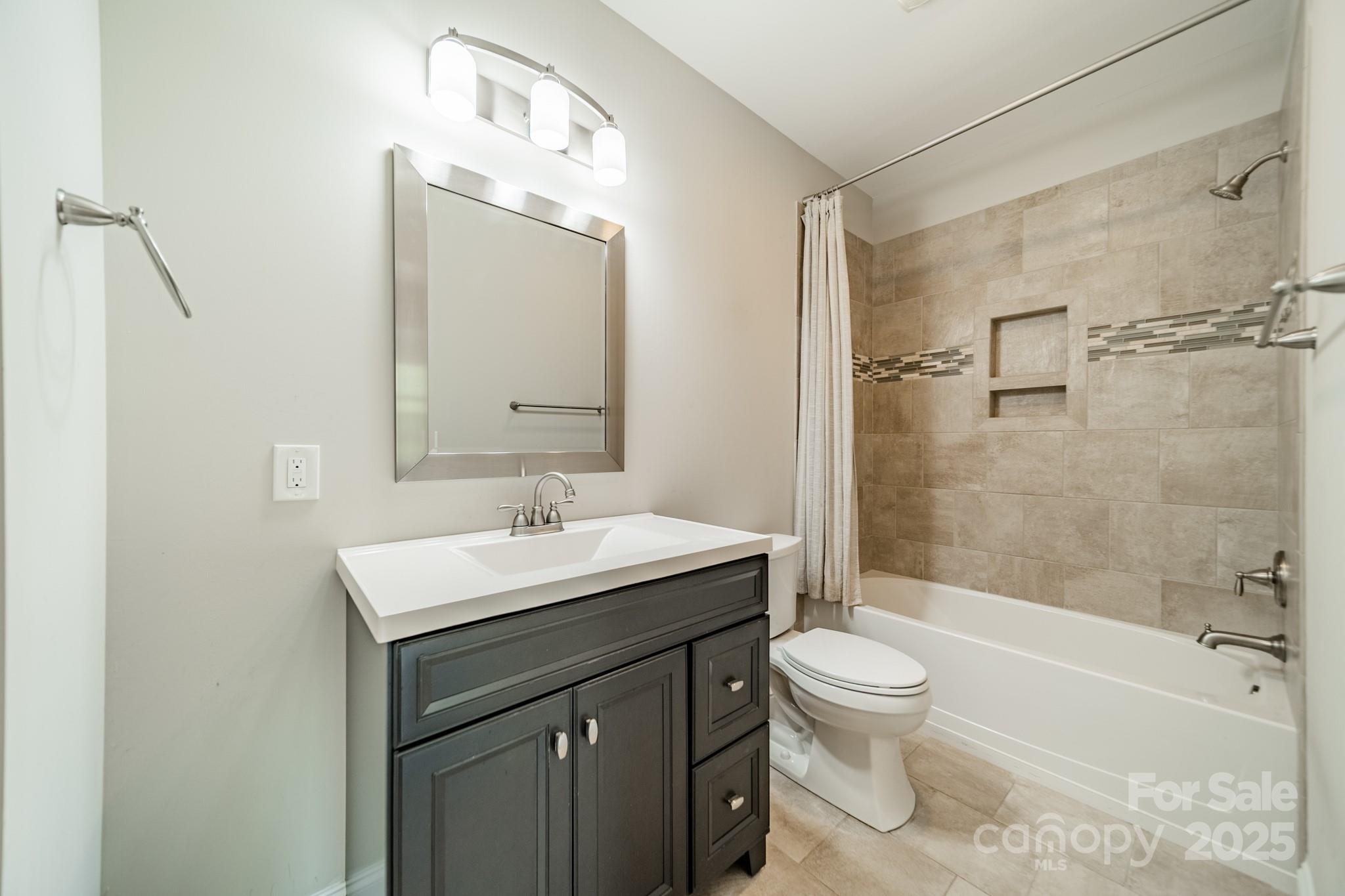 9229 Inverness Bay Road Charlotte, NC 28278 - Photo 30 of 41 a bathroom with a sink a toilet and shower