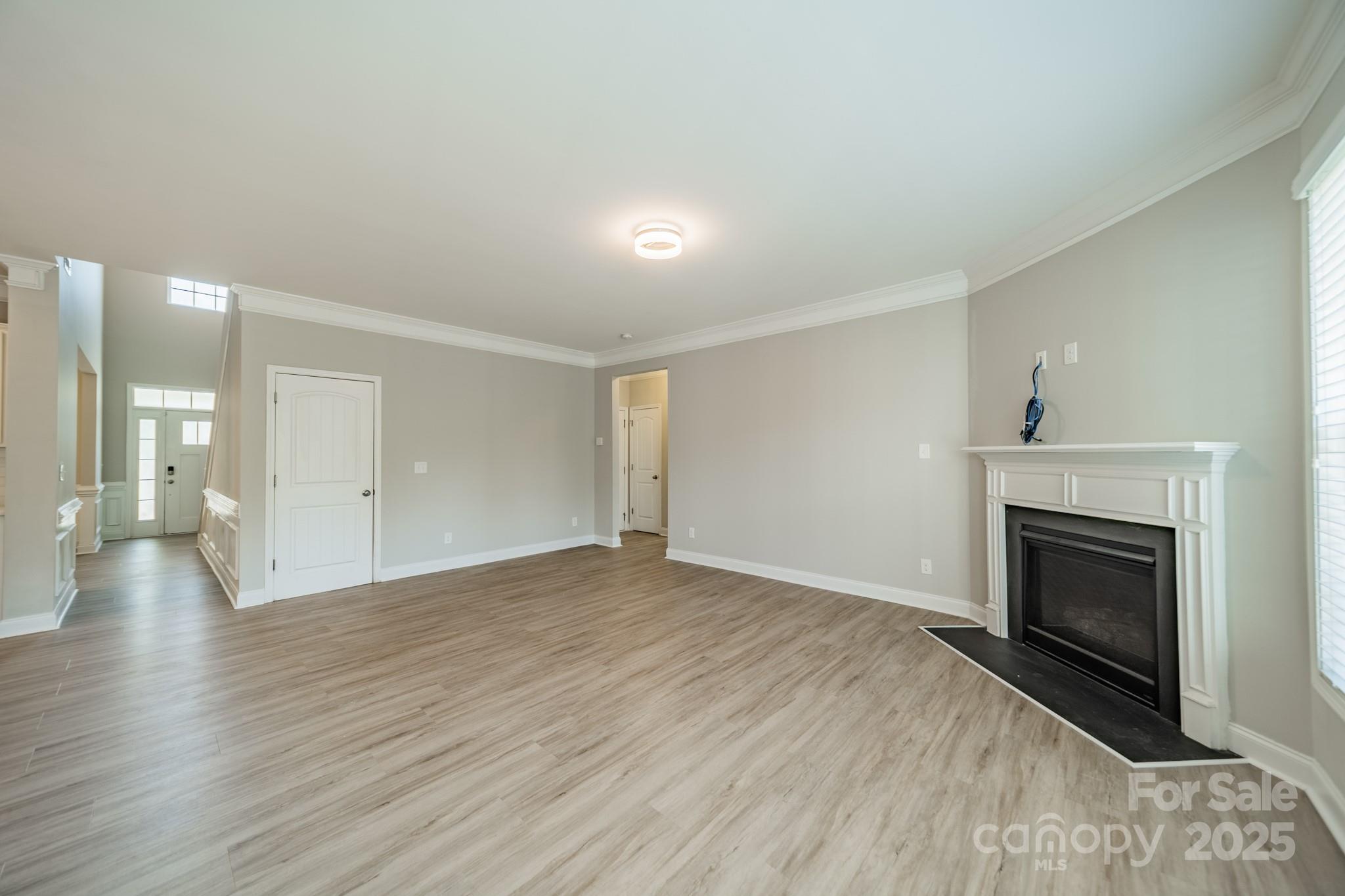 9229 Inverness Bay Road Charlotte, NC 28278 - Photo 7 of 41 an empty room with wooden floor and fireplace
