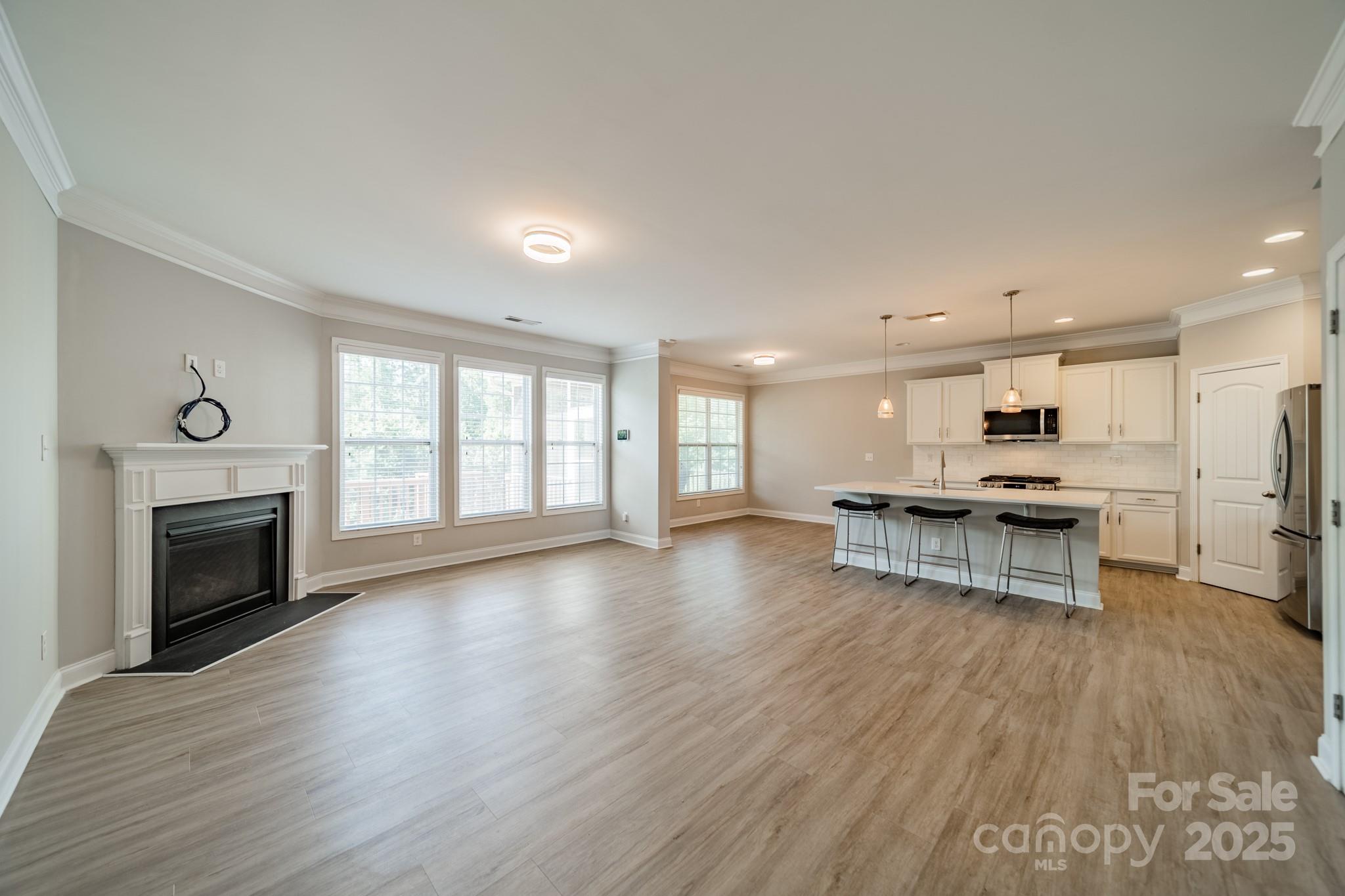 9229 Inverness Bay Road Charlotte, NC 28278 - Photo 8 of 41 a view of kitchen with microwave a stove and wooden floors