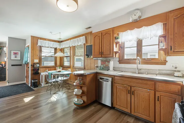 a open kitchen with sink cabinets and wooden floor
