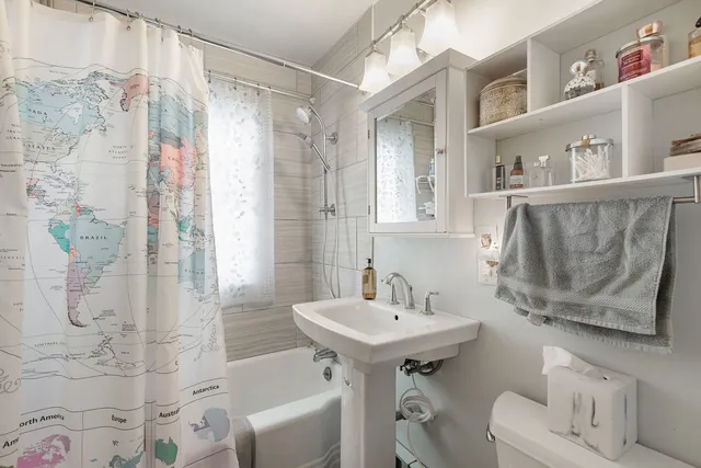 a bathroom with a sink toilet and shower