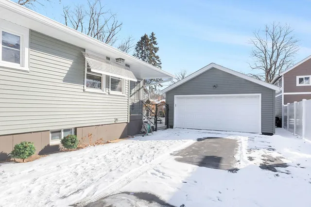 a view of a house with snow on the road