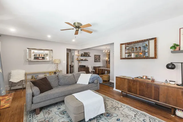 a living room with furniture and wooden floor