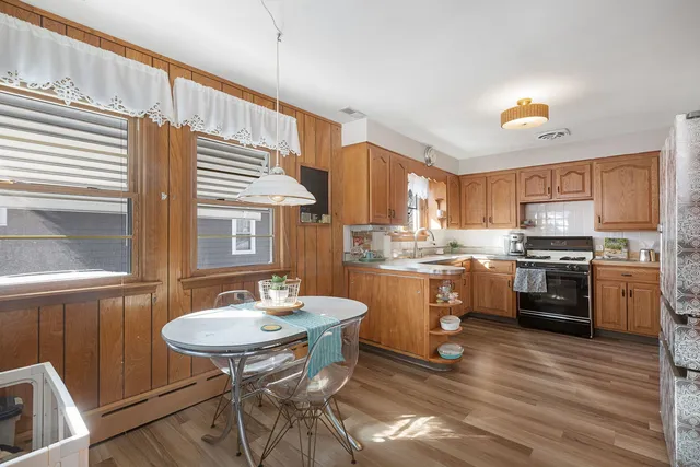 a kitchen with a sink cabinets and wooden floor