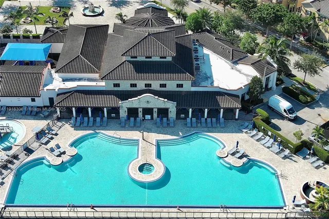 an aerial view of a house with swimming pool