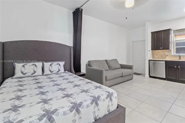 a bedroom with a large bed and a couch