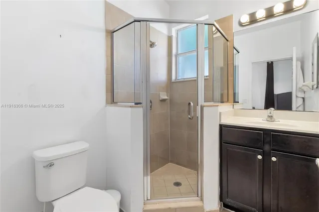 a bathroom with a shower a sink and a mirror