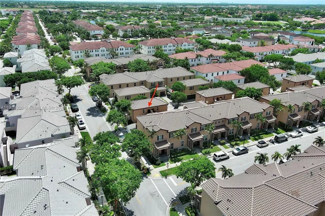 an aerial view of residential houses with outdoor space