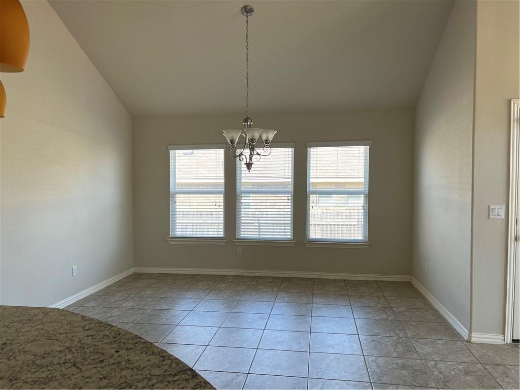 3645 Rams Horn Way Round Rock, TX 78665 - Photo 4 of 16 Unfurnished dining area featuring lofted ceiling, healthy amount of natural light, hanging lights, and light tile patterned floors