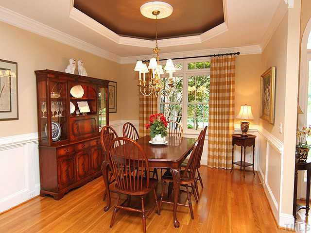 4636 Hidden Harbor Lane Raleigh, NC 27615 - Photo 3 of 16 View of Dining Room from Living Room. Tray ceiling has additional lighting inside the tray. Note the beautiful mouldings and millwork.