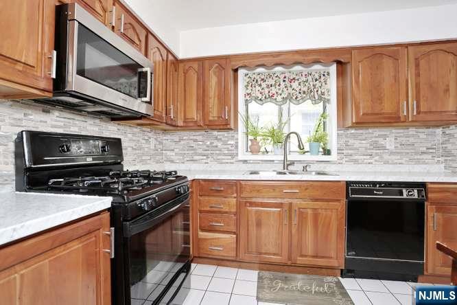 290 Hamilton Place, Unit 4 Hackensack, NJ 07601 - Photo 11 of 50 a kitchen with granite countertop a stove top oven microwave and cabinets
