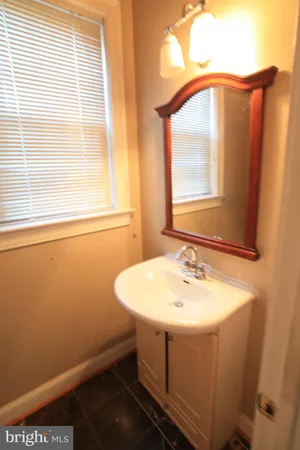 a bathroom with a sink and a window